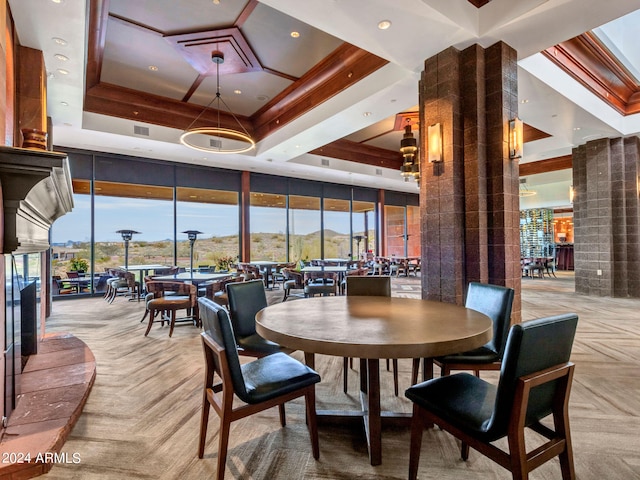 dining space featuring a mountain view, decorative columns, and a raised ceiling