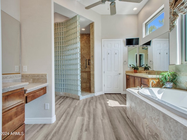 bathroom featuring vanity, a high ceiling, separate shower and tub, ceiling fan, and hardwood / wood-style flooring