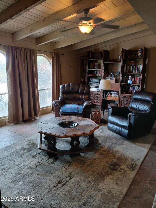 living room with ceiling fan, wooden ceiling, and beamed ceiling