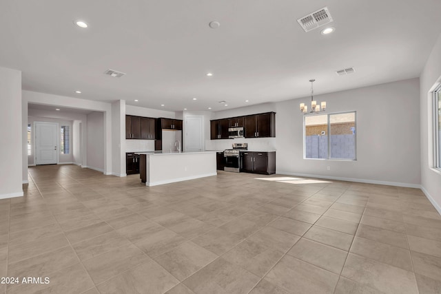 unfurnished living room with light tile patterned floors and a chandelier