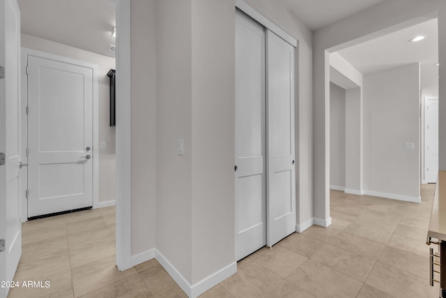 corridor with light tile patterned floors