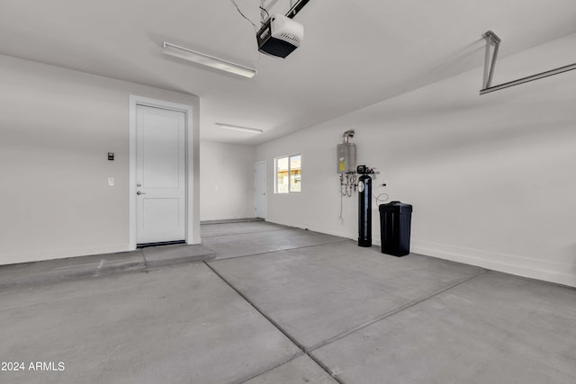 garage with a garage door opener and water heater