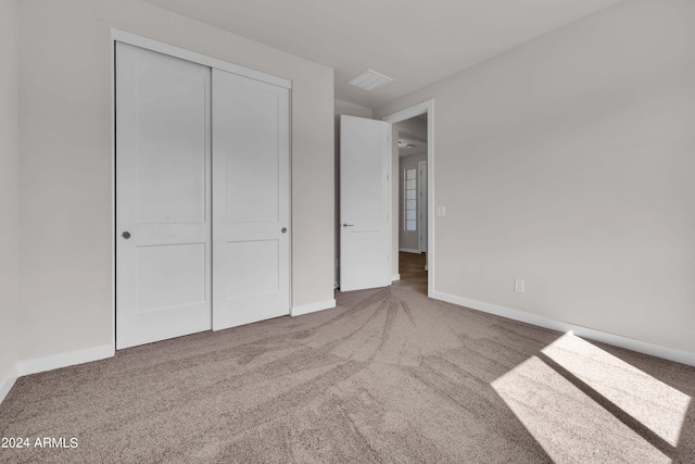 unfurnished bedroom featuring a closet and carpet