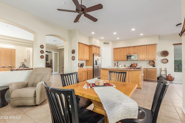 tiled dining room with ceiling fan