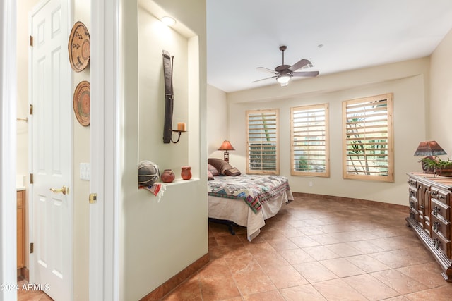 tiled bedroom featuring ceiling fan