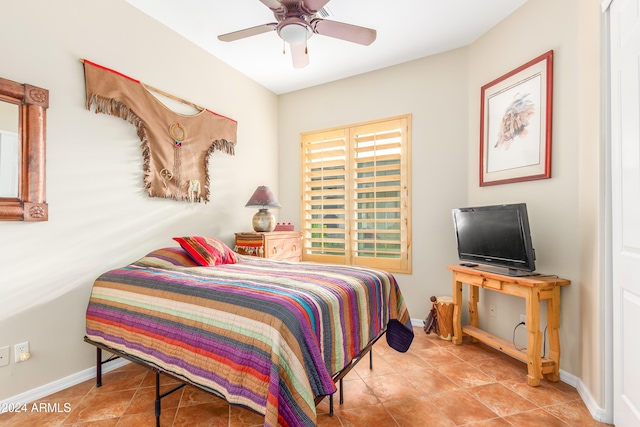 tiled bedroom featuring ceiling fan