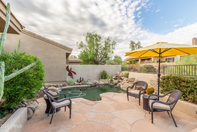 view of patio featuring a fenced in pool