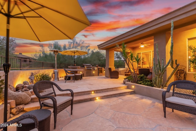 view of patio terrace at dusk