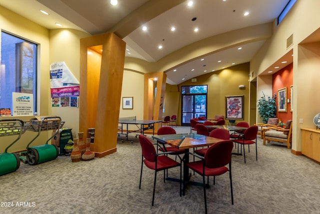 interior space featuring high vaulted ceiling and carpet