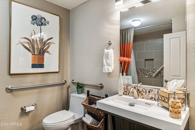 bathroom featuring sink, toilet, and decorative backsplash