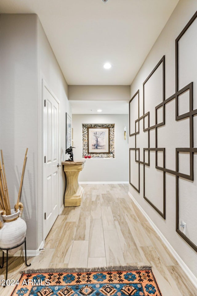 hall with light hardwood / wood-style floors