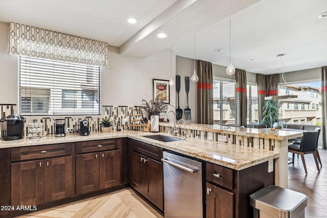 kitchen with hanging light fixtures, sink, light parquet flooring, and a wealth of natural light