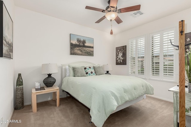 bedroom featuring carpet floors, baseboards, visible vents, and ceiling fan