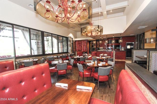 dining room with visible vents, a chandelier, and wood finished floors