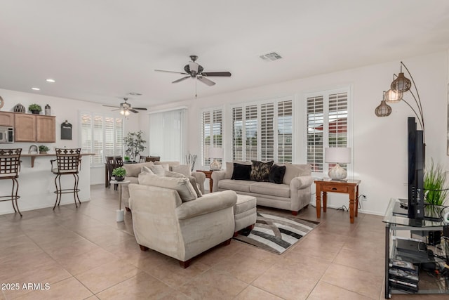 living area featuring recessed lighting, visible vents, and light tile patterned floors