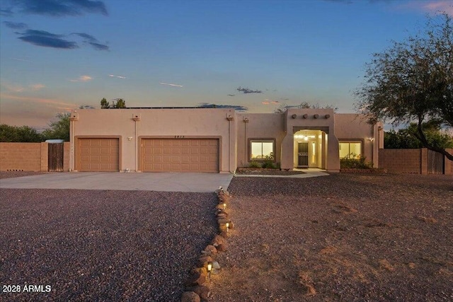 2815 W Irvine Rd, Phoenix, AZ 85086 - southwest-style home featuring an attached garage, driveway, and stucco siding