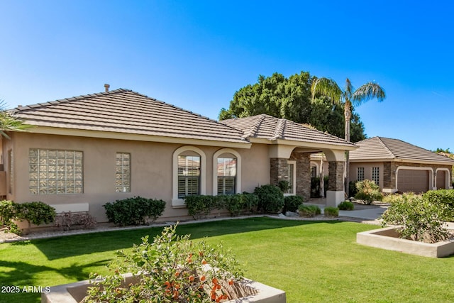 view of front of property featuring a garage and a front lawn