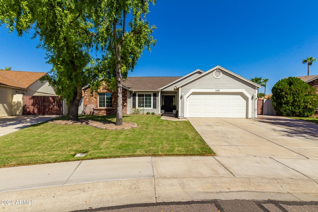 ranch-style home with a front lawn and a garage