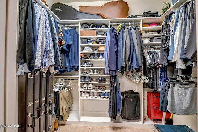 walk in closet featuring tile patterned flooring