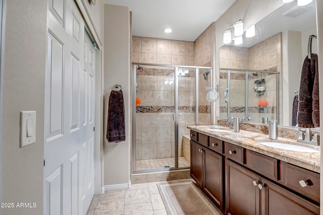 bathroom with tile patterned flooring, vanity, and an enclosed shower