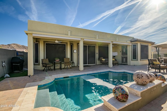 view of pool featuring area for grilling, a patio area, and ceiling fan