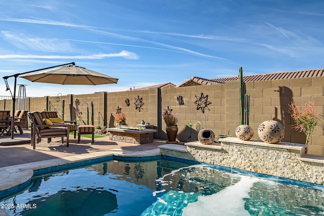 view of swimming pool featuring an outdoor fire pit and a patio area