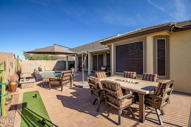 view of patio / terrace with a fenced in pool and a fire pit