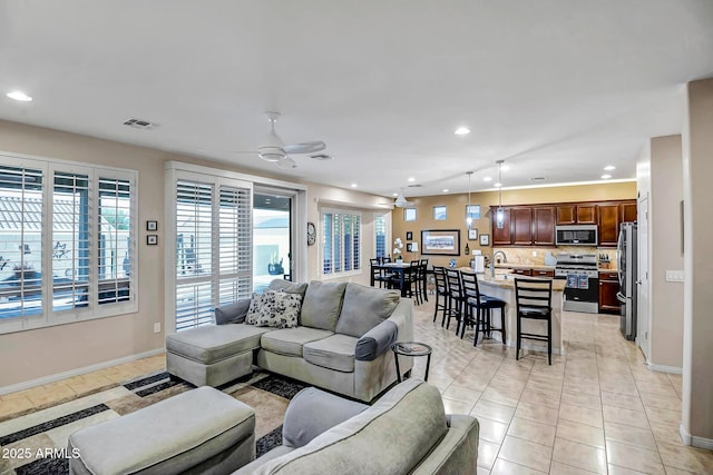 living room featuring ceiling fan and light tile patterned floors