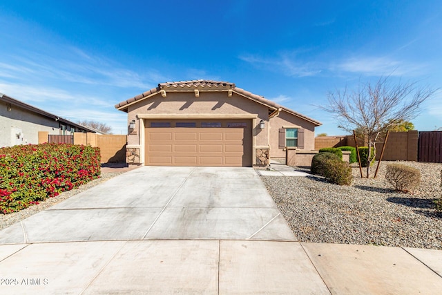 view of front of house with a garage, fence, concrete driveway, stone siding, and stucco siding