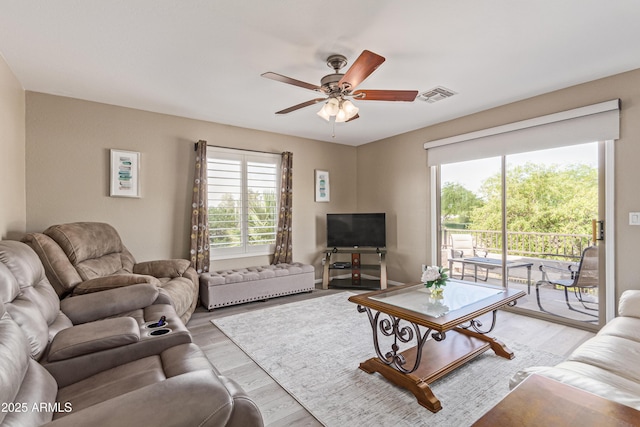 6847 S 27th Pl, Phoenix, AZ 85042 - living room with light wood finished floors and a ceiling fan