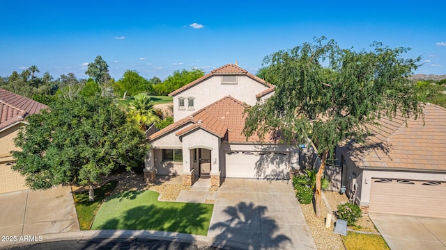 6847 S 27th Pl, Phoenix, AZ 85042 - mediterranean / spanish home featuring a tiled roof, stucco siding, concrete driveway, an attached garage, and a front yard