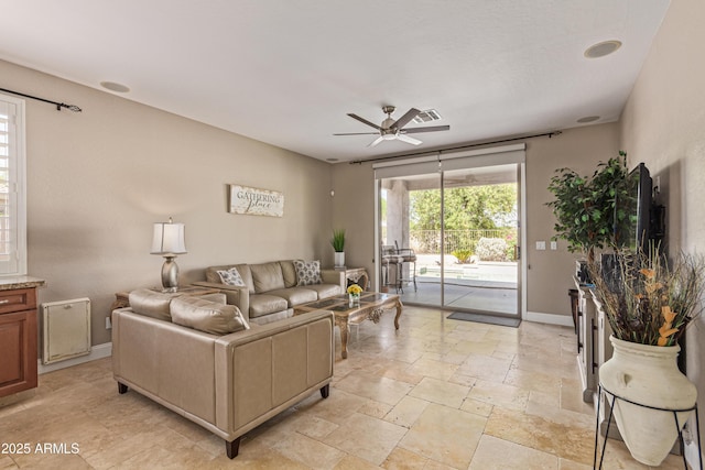 6847 S 27th Pl, Phoenix, AZ 85042 - living area with a ceiling fan, baseboards, and stone tile floors