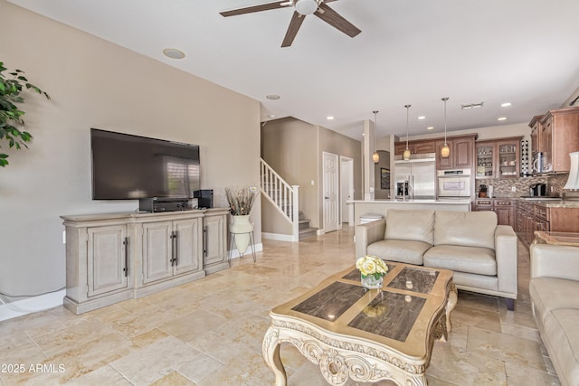6847 S 27th Pl, Phoenix, AZ 85042 - living room featuring a ceiling fan, stairs, baseboards, recessed lighting, and light stone finish flooring