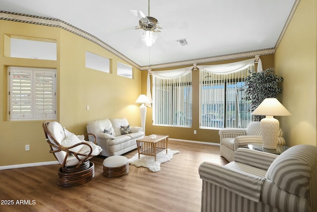 sitting room with a wealth of natural light, visible vents, and wood finished floors