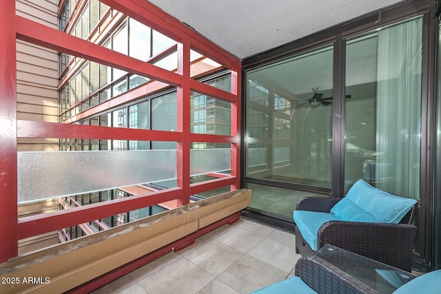 sunroom featuring ceiling fan