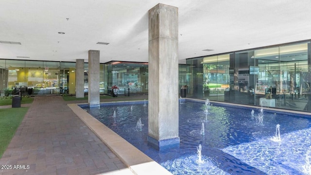 view of swimming pool with pool water feature