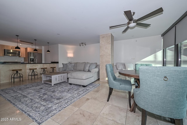 tiled living room featuring ceiling fan