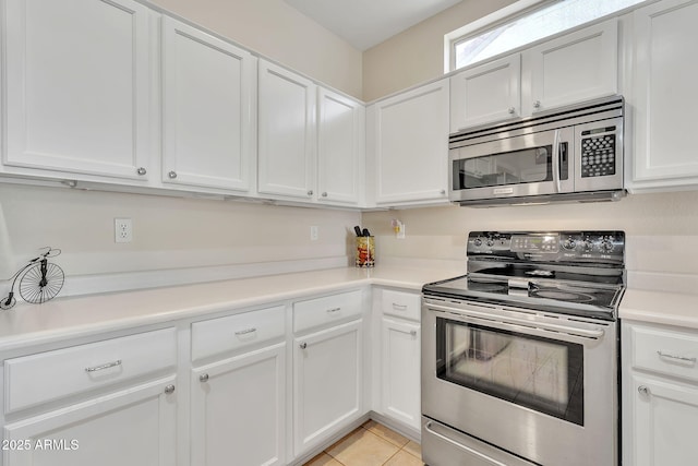 kitchen featuring appliances with stainless steel finishes, light countertops, white cabinetry, and light tile patterned floors