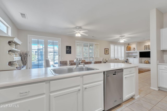 kitchen with light tile patterned floors, visible vents, open floor plan, stainless steel dishwasher, and a sink