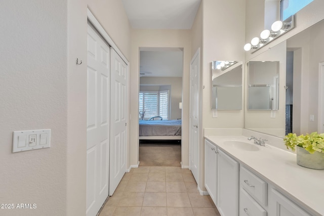 full bathroom featuring ensuite bath, tile patterned flooring, vanity, and baseboards