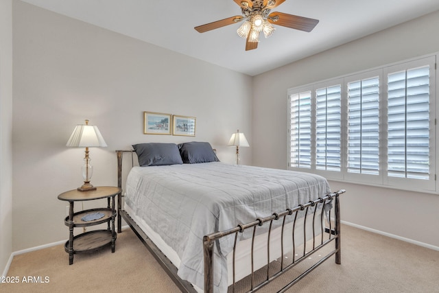 carpeted bedroom featuring a ceiling fan and baseboards