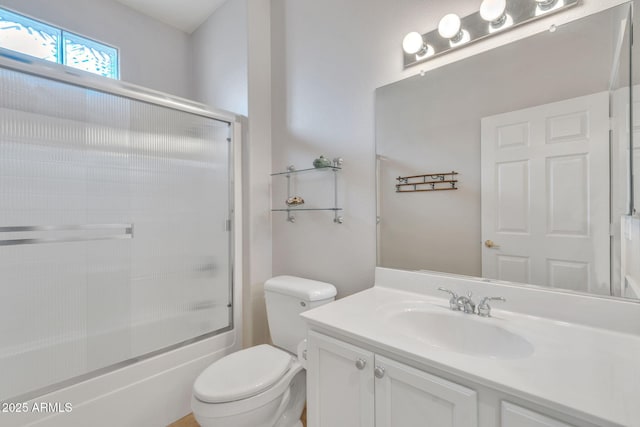 full bathroom with toilet, enclosed tub / shower combo, and vanity