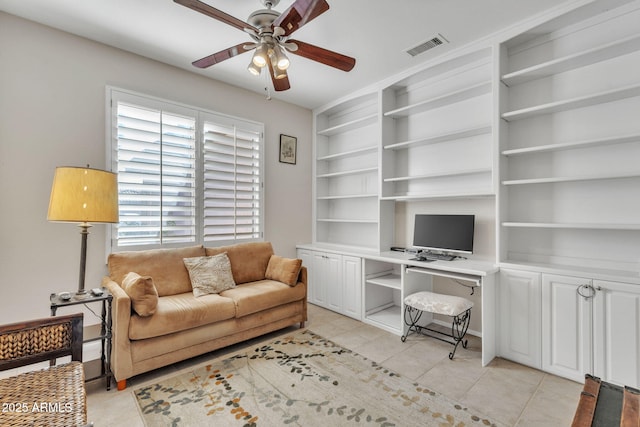 living room featuring built in desk, visible vents, a ceiling fan, and light tile patterned flooring