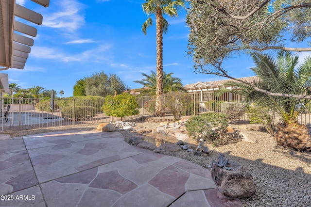 view of patio featuring fence