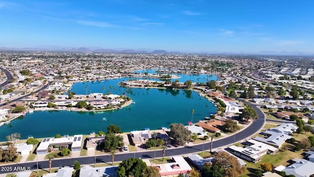 drone / aerial view with a water view and a residential view