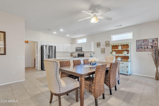 dining room featuring a healthy amount of sunlight, visible vents, baseboards, and light tile patterned floors