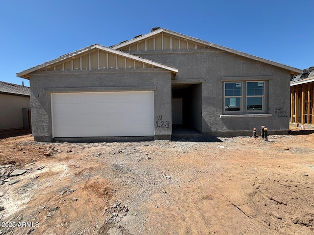 46868 W Old Timer Rd, Maricopa, AZ 85139 - unfinished property featuring a garage, stucco siding, board and batten siding, and dirt driveway