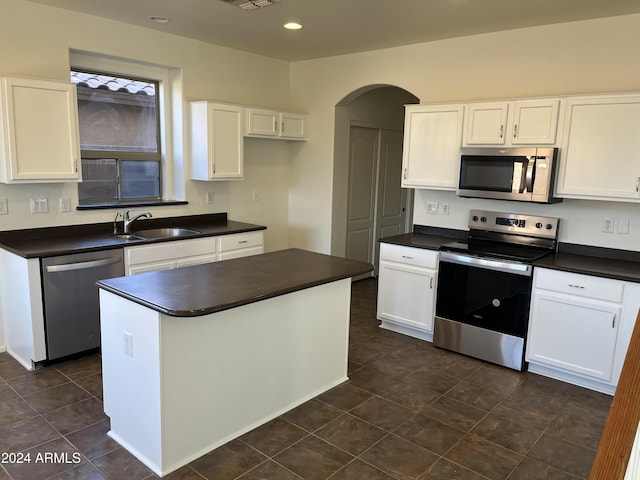 kitchen with white cabinets, appliances with stainless steel finishes, and sink