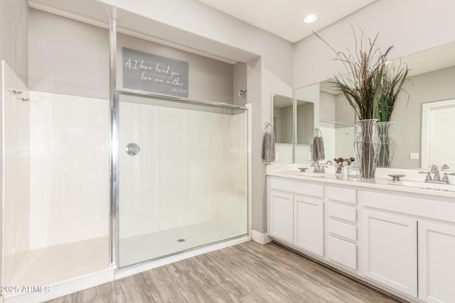 bathroom with vanity, wood-type flooring, and walk in shower