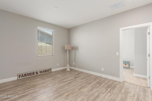 spare room featuring light wood-type flooring